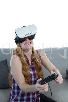 Woman playing video game with virtual reality headset