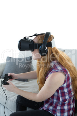 Woman playing video game with virtual reality headset