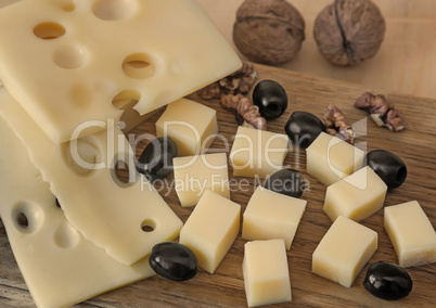 Cheese and walnuts on a plate.