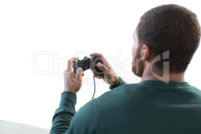 Man playing video game against white background