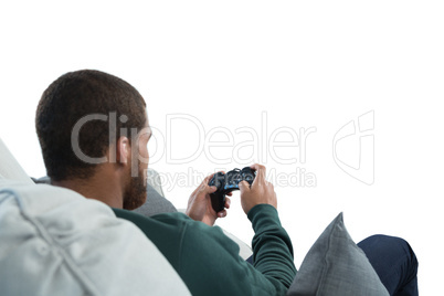 Man playing video game against white background