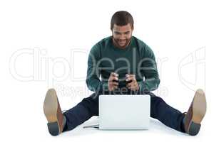 Man playing video game on laptop