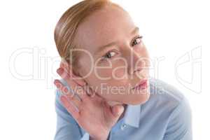 Businesswoman listening secretly with hands behind her ears
