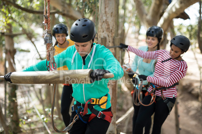 Friends ready to zip line in park