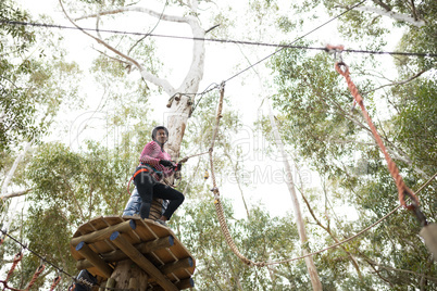 Woman enjoying zip line adventure in park