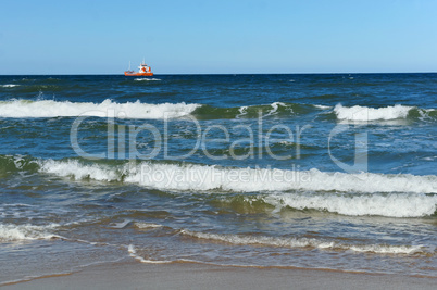 ship in the sea on the horizon, Sea waves on the beach, a storm in the Baltic sea