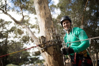 Man attaching carabiner to rope