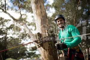 Man attaching carabiner to rope