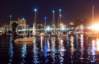 boats pass along the river at night