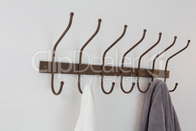 Close-up of bathrobe and shirt hanging on hook