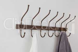 Close-up of bathrobe and shirt hanging on hook