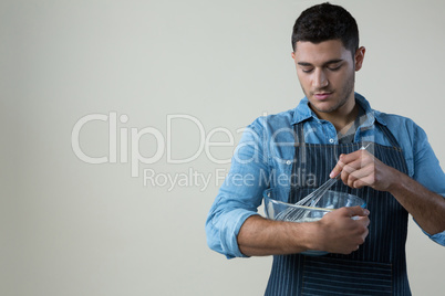 Chef holding a whisk in the bowl