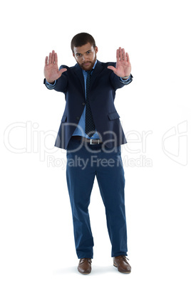 Businesswoman making stop sign against white background