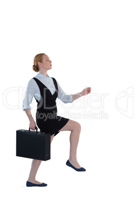 Female executive pretending to climb the steps