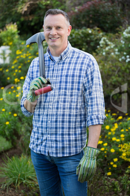Man holding gardening tool in garden