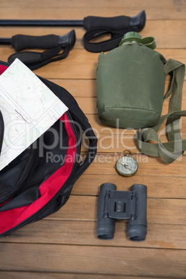 Various travel equipment on wooden floor