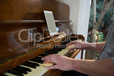 Man playing piano at home