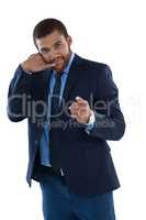 Businessman gesturing against white background