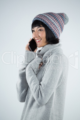 Woman in winter clothing talking on mobile phone