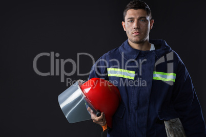 Fireman holding a safety helmet