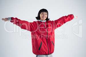 Smiling woman standing with arms outstretched