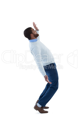 Male executive balancing while walking against white background