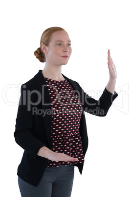 Businesswoman taking oath against white background
