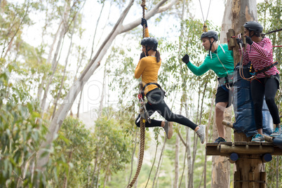 Woman enjoying zip line adventure in park