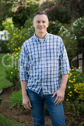 Smiling man standing in garden