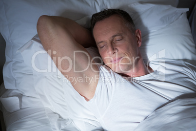 Man sleeping on bed in bedroom