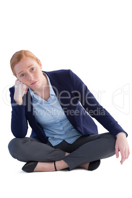 Businesswoman sitting against white background