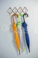 Colorful umbrellas hanging on hook