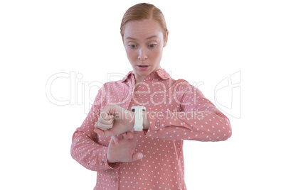 Female executive looking at her smartwatch