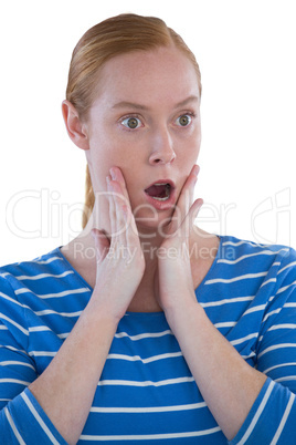 Woman with shocked facial expression with hand on face