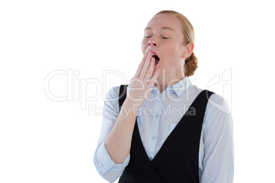 Female executive yawning against white background
