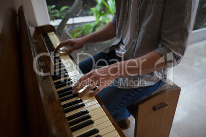 Man playing piano at home