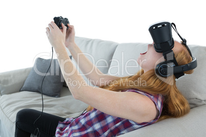 Woman playing video game with virtual reality headset