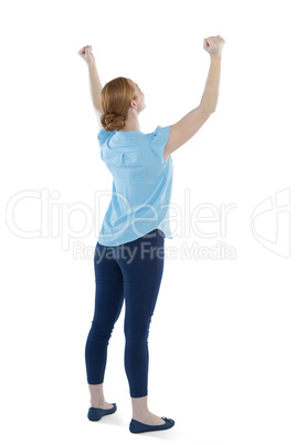 Female executive standing with arms up against white background