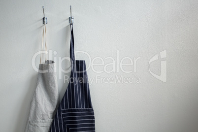 Aprons hanging on hook