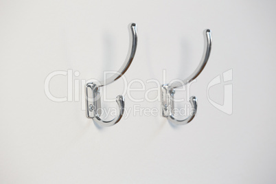 Empty hooks attached on wall