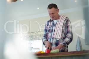Man chopping vegetables in kitchen