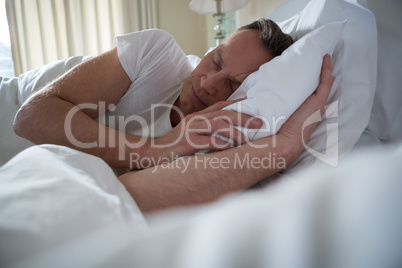 Man sleeping on bed in bedroom