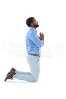Male executive praying against white background
