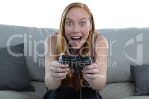 Woman playing video game against white background