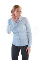 Female executive listening secretly with hands behind her ears