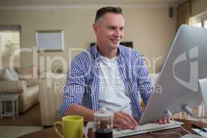 Man working on computer in living room