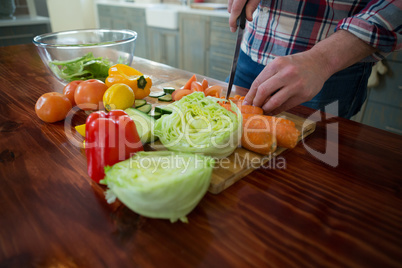 Man chopping vegetables in kitchen