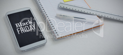 Composite image of mobile phone and stationery on white background