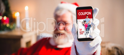 Composite image of santa claus sitting and showing his smartphone