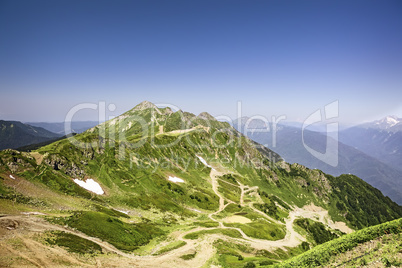 The mountainous landscape of the slopes covered by forest.